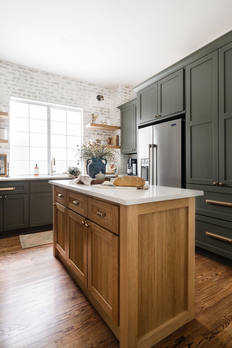 Oak island, integrated refrigerator surround, and green cabinetry