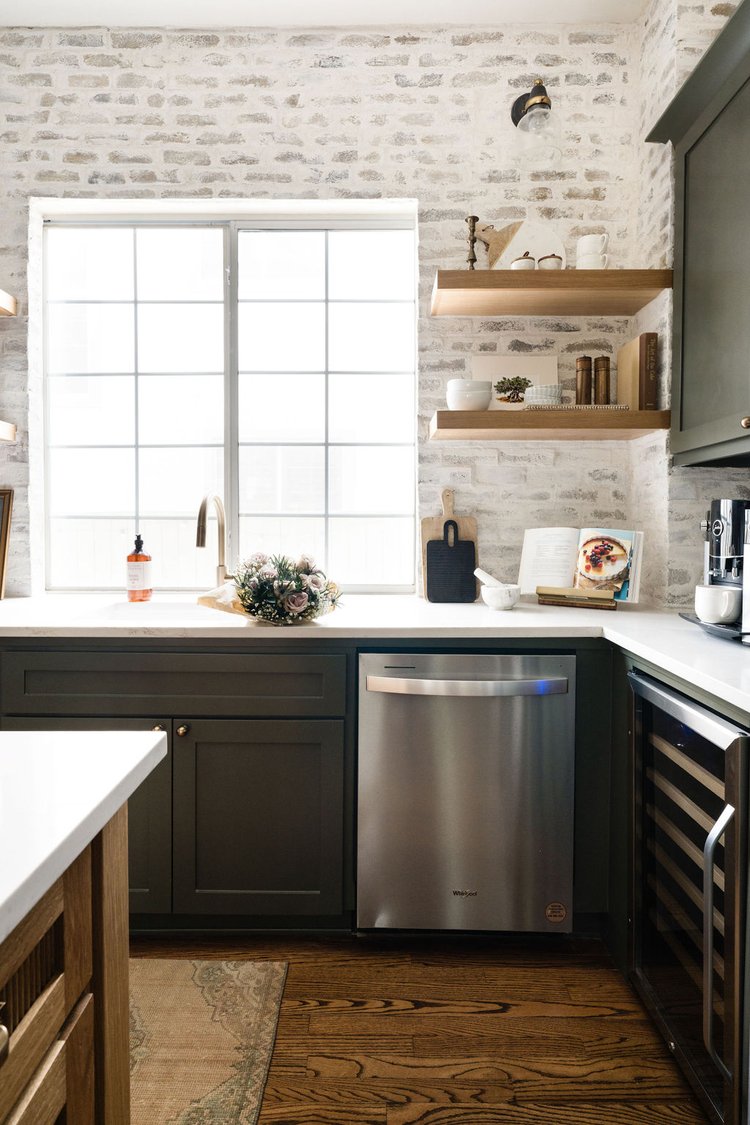 Kitchen sink, dishwasher, wine fridge, and oak floating shelves